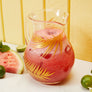 Glass pitcher with gold palms.