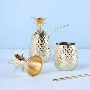 Gold pineapple shaped drink tumbler with straw.