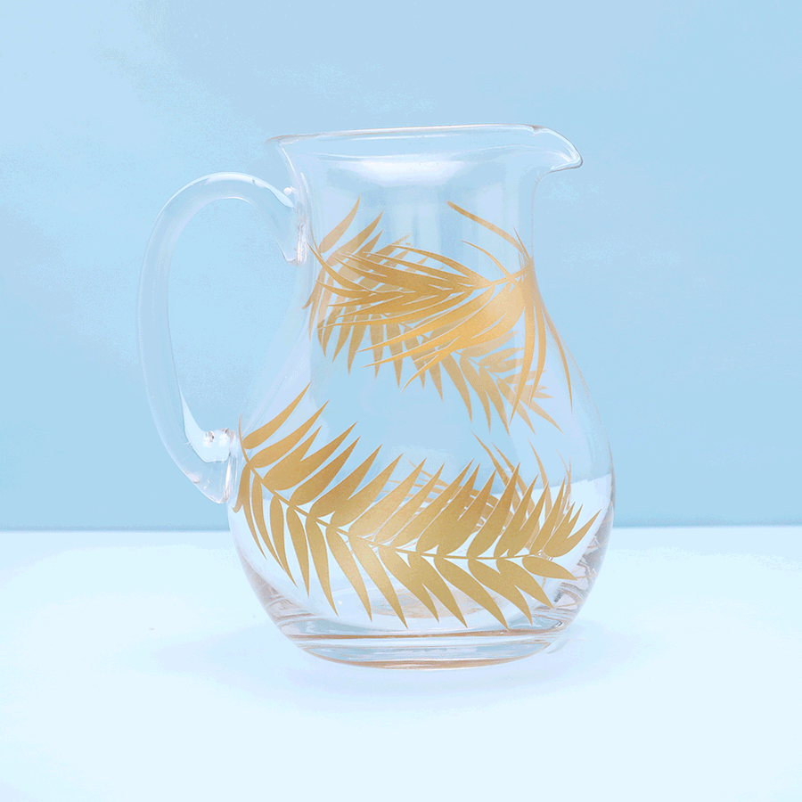 Glass pitcher with gold palms.